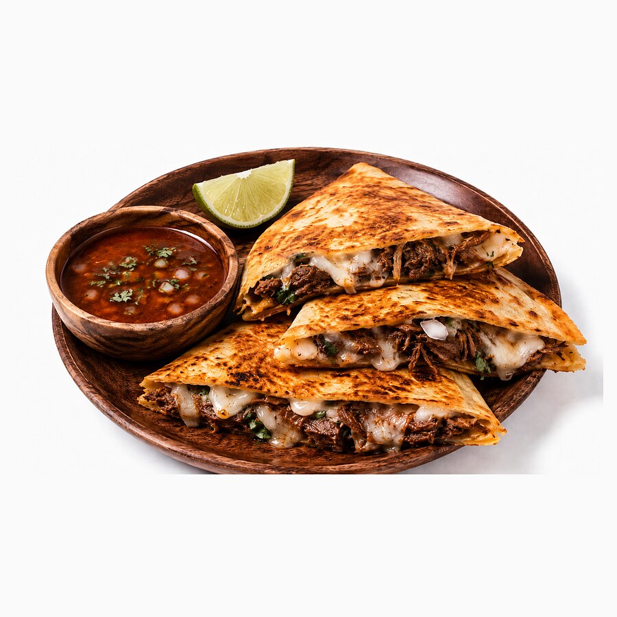 Birria quesadilla quarters filled with melted cheese and shredded beef, with consomme and lime